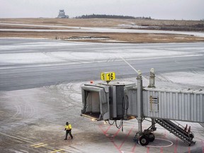 Food service workers say they have reached a tentative agreement with airline caterer Gate Gourmet nearly two weeks after walking off the job, meaning travellers through Toronto may soon find a full menu option on flights once again. A worker walks on the tarmac at the Halifax Stanfield International Airport in Halifax on Thursday, Jan. 4, 2018.