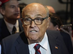Rudy Giuliani speaks to reporters