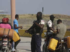 A National Police officer patrols an intersection in Port-au-Prince, Haiti, Saturday, April 6, 2024.