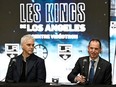 Quebec Finance Minister Eric Girard, right, speaks at a news conference, Tuesday, Nov. 14, 2023 at the Videotron Centre in Quebec City. Luc Robitaille, president of the L.A. Kings, left, looks on.