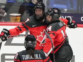 Canada's Laura Stacey (7) celebrates her goal over Czechia with teammates Renata Fast (14) and Blayre Turnbull (40) during third period hockey action at the IIHF Women's World Hockey Championship in Utica, N.Y., Sunday, April 7, 2024.