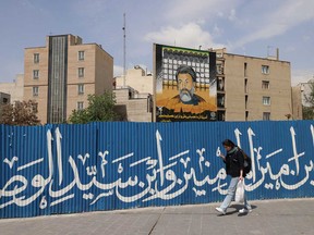 An Iranian walks down a street in Tehran on April 13, 2024.