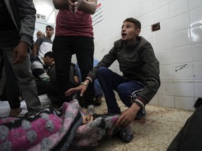 A Palestinian reacts to seeing the young victim of an Israeli airstrike, at Al Aqsa Hospital in Deir al Balah, central Gaza Strip, Monday, April 22, 2024.