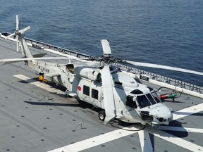 FILE - An SH-60K anti-submarine helicopter sits on the flight deck of Japan's Maritime Self Defense Force (JMSDF) helicopter carrier JS Izumo (DDH-183) off the coast of Brunei on June 26, 2019. Late Saturday, April 20, 2024, contact was lost with two Japanese navy SH-60K choppers carrying eight crewmembers, believed to have crashed in the Pacific Ocean south of Tokyo during a night-time training exercise, and rescuers were searching for the missing, Japan's defense minister said.