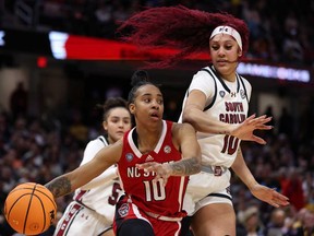 Aziaha James #10 of the NC State Wolfpack dribbles around Kamilla Cardoso #10 of the South Carolina Gamecocks in the second half during the NCAA Women's Basketball Tournament Final Four semifinal game at Rocket Mortgage Fieldhouse on April 5, 2024 in Cleveland, Ohio.