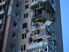 This photograph taken on April 4, 2024 shows a residential building damaged as a result of a missile attack in Kharkiv, amid the ongoing Russian-Ukrainian conflict.
