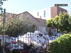 A piles of garbage is seen outside a home in Los Angeles known by neighbours as "trash house."