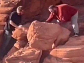 Two men allegedly seen in a screengrab of a video damaging the rock formations at Lake Mead National Recreation Area in Nevada.