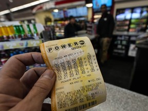 FILE - A Powerball lottery ticket is seen inside a convenience store, Monday, April 1, 2024, in Kennesaw, Ga. Powerball will match a record for lottery losing Saturday night, April 6, with a stretch of more than three months without a jackpot winner.