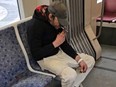 Screenshot of man smoking crack on TTC streetcar.