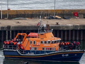 Migrants are brought into Dover Port by a RNLI lifeboat after being picked up in the English Channel while trying to make the journey from France in inflatable dinghies on April 23, 2024 in Dover, England.
