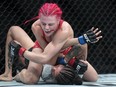 Gillian (The Savage) Robertson, top, fights Polyana Viana during the Women's Strawweight bout at UFC 297 in Toronto on Saturday, January 20, 2024. Canadians Robertson and Marc-Andre (Powerbar) Barriault have been added to Conor McGregor's comeback fight card.