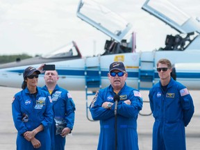NASA’s Boeing Crew Flight Test Commander Butch Wilmore (centre) and Pilot Suni Williams (left) address the media after arriving at the Kennedy Space Center on April 25, 2024 in Cape Canaveral, Fla.