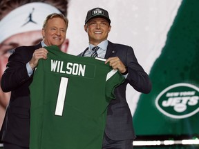 BYU quarterback Zach Wilson holds a New York Jets jersey with NFL commissioner Roger Goodell after being selected second overall by the team in the first round of the NFL football draft, Thursday, April 29, 2021, in Cleveland.