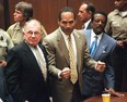 Murder defendant O.J. Simpson (centre) listens to the not guilty verdict with his attorneys F. Lee Bailey (left) and Johnnie Cochran Jr. (right) in Los Angeles on Oct. 3, 1995.