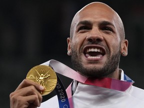 FILE - Lamont Marcell Jacobs, of Italy poses with his gold medal following the men's 100-meters final at the 2020 Summer Olympics, Monday, Aug. 2, 2021, in Tokyo. Track and field is set to become the first sport to introduce prize money at the Olympics, with World Athletics saying Wednesday, April 10, 2024, it would pay $50,000 to gold medalists in Paris.