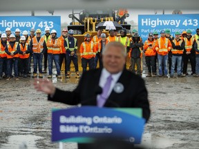 With a backdrop of tradespeople, Ontario Premier Doug Ford speaks to cameras and guests during an announcement for the building of Ontario Highway 413, in Caledon, Ont., Tuesday, April 30, 2024. &ampnbsp;THE CANADIAN PRESS/Cole Burston