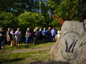 People take part in a vigil at the Women's Monument in Petawawa, Ont., following the jury's release of recommendations in the Borutski Inquest in Pembroke, Ont., on Tuesday, June 28, 2022.