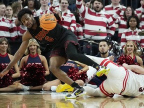 Southern California guard Bronny James (6) scrambles for the bal lwith Arizona guard Pelle Larsson (3) during the first half of an NCAA college basketball game in the quarterfinal round of the Pac-12 tournament Thursday, March 14, 2024, in Las Vegas.