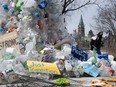 A person walks past a public art installation outside a United Nations conference on plastics on Tuesday, April 23, 2024 in Ottawa.