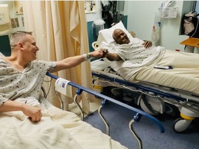 Russ Redhead, left, gives James Harris Jr. a fist bump before kidney transplant surgery at the University of Maryland Medical Center in February. MUST CREDIT: University of Maryland Medical Center