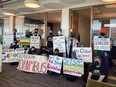 Pro-Palestinian protesters holding up colourful signs at Google office.