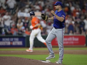 Texas Rangers relief pitcher Brock Burke reacts after giving up a two-run home run to Houston Astros' Kyle Tucker during the seventh inning of a baseball game Friday, April 12, 2024, in Houston.