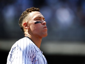 New York Yankees' Aaron Judge looks out from the dugout during the seventh inning inning of a baseball game against the Tampa Bay Rays, Saturday, April 20, 2024 in New York.