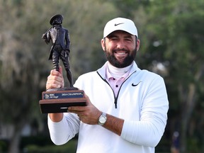 Scottie Scheffler of the United States celebrates with the trophy after winning during the continuation of the final round of the RBC Heritage at Harbour Town Golf Links on April 22, 2024 in Hilton Head Island, South Carolina.