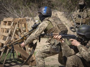 Members of the Siberian Battalion, which was formed mostly of volunteer Russian citizens, of the Ukrainian Armed Forces' International Legion, practice during military exercises, amid Russia's attack on Ukraine, at an undisclosed location in Kyiv region, Ukraine, Wednesday, Apr. 10, 2024.