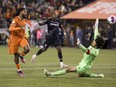 Forge FC forward Beni Badibanga (left) scores past Cavalry FC goalkeeper Marco Carducci during Canadian Premier League final soccer action in Hamilton on Saturday, Oct. 28, 2023. It appears Canadian Soccer Business and Mediapro have solved their broadcast differences.