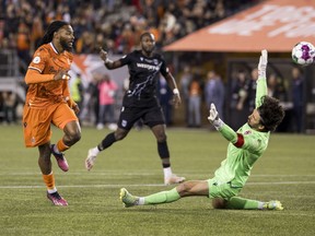 Forge FC forward Beni Badibanga (left) scores past Cavalry FC goalkeeper Marco Carducci during Canadian Premier League final soccer action in Hamilton on Saturday, Oct. 28, 2023. It appears Canadian Soccer Business and Mediapro have solved their broadcast differences.