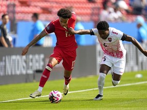 Canada forward Tajon Buchanan (17) control the ball under pressure from Trinidad and Tobago defender Andre Raymond (6) in the second half of a CONCACAF Nations League play-in soccer match, Saturday, March 23, 2024, in Frisco, Texas. Canada moved up one place to No. 49 in the latest FIFA men's rankings.THE CANADIAN PRESS/AP/Julio Cortez
