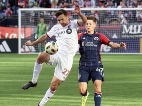 Toronto FC defender Shane O'Neill (27) defends the ball against New England Revolution forward Esmir Bajraktarevic (47) in the second half of an MLS soccer match Sunday, March 3, 2024, in Foxborough, Mass.