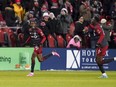 Toronto FC's Tyrese Spicer (left) celebrates his goal against Atlanta United with teammate Aime Mabika during first half MLS soccer action in Toronto on Saturday, March 23, 2024. Everything is new these days for Spicer, from scoring his first MLS goal to seeing himself in a video game.