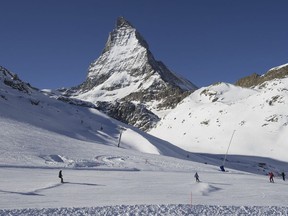 Skiers ride down the slopes at Riffelberg with Mount Matterhorn in the background, on Jan. 16, 2012, in Zermatt in the canton of Valais, Switzerland.