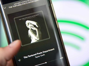 This photograph taken in Paris on April 19, 2024, shows a smatphone displaying the U.S. singer-songwriter Taylor Swift's new album "The Tortured Poets Department" on Spotify.