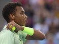 Felix Auger-Aliassime of Canada prepares to serve to Daniil Medvedev of Russia during their third-round match at the Australian Open tennis championships at Melbourne Park, Melbourne, Australia, Saturday, Jan. 20, 2024. Auger-Aliassime was eliminated from the clay-court Monte Carlo Masters tournament on Wednesday after dropping a second-round match 6-4, 7-5 to Lorenzo Sonego of Italy.