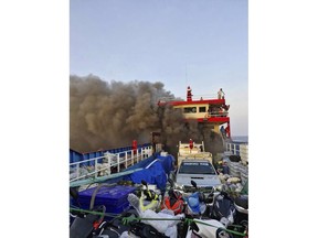 Smoke rises from a ferry in Surat Thani province, Thailand, Thursday, April 4, 2024.