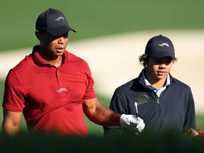 Tiger Woods of the United States warms up in the practice area with his son Charlie Woods during the final round of the 2024 Masters Tournament at Augusta National Golf Club on April 14, 2024 in Augusta, Ga.