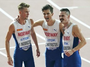 FILE - From left, brothers Filip Ingebrigtsen, Jakob Ingebrigtsen, and Henrik Ingebrigtsen, of Norway, react after competing in the men's 5000 meter final at the World Athletics Championships in Doha, Qatar, on Sept. 30, 2019. Father of Ingebrigtsen brothers is charged with abuse of "one of his minor children," lawyer says.