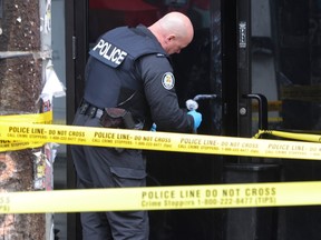 Toronto Police investigate a triple shooting that killed one man and wounded two other people on Queen St. W., near Portland St., on Thursday, April 11, 2024.