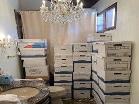 This image, contained in the indictment against former President Donald Trump, shows boxes of records stored in a bathroom and shower in the Lake Room at Trump's Mar-a-Lago estate in Palm Beach, Fla. A federal judge is set to hear arguments on whether to dismiss the classified documents prosecution of Donald Trump. His lawyers say the former president was entitled under the Presidential Records Act to keep the sensitive documents with him when he left the White House and headed to Florida. (Justice Department via AP)