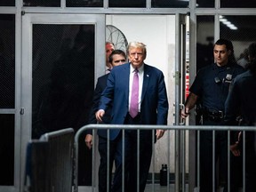 Former U.S. president Donald Trump steps outside the courtroom during a break at his trial for allegedly covering up hush money payments linked to extramarital affairs, at Manhattan Criminal Court in New York City on April 19, 2024.