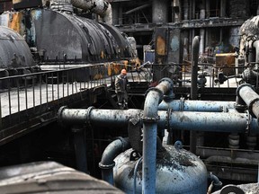 A worker walks past scorched equipments in a turbine hall at a power plant of energy provider DTEK, destroyed after an attack, in an undisclosed location in Ukraine on April 19, 2024, amid the Russian invasion of Ukraine.
