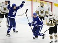 Toronto Maple Leafs' John Tavares (91) and Matthew Knies (23) celebrate a goal on Boston Bruins goaltender Jeremy Swayman.
