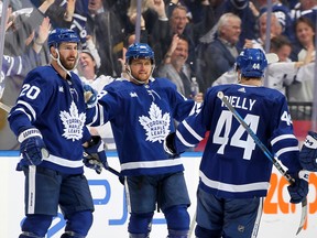 Joel Edmundson #20, William Nylander #88, and Morgan Rielly #44 of the Toronto Maple Leafs celebrate after Nylander's goal against the Boston Bruins.
