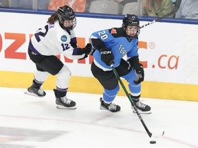 Toronto's Sarah Nurse, right, protects the puck from Minnesota's Kelly Pannek.