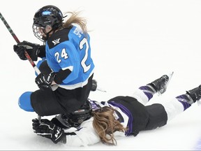 Toronto's Natalie Spooner is tripped up by Minnesota's Mellissa Channell.