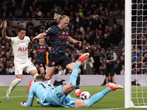 Guglielmo Vicario of Tottenham Hotspur fails to save a cross from Kevin De Bruyne of Manchester City (not pictured) before Erling Haaland scores.